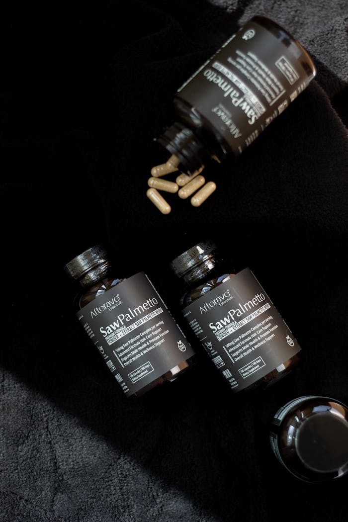 Flat lay of saw palmetto bottles and capsules, ideal for wellness and health concepts.